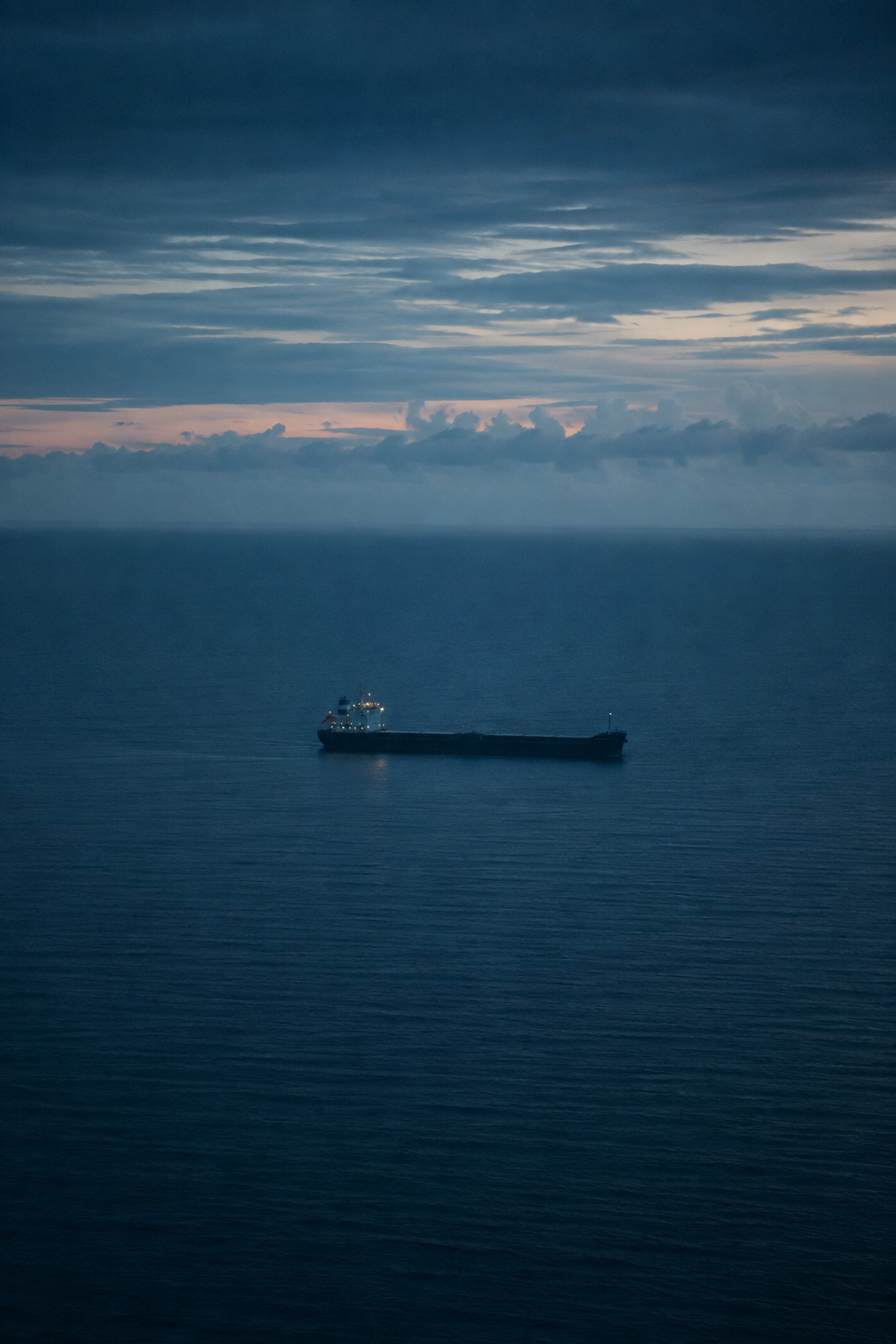 Commercial vessel at sea during blue hour